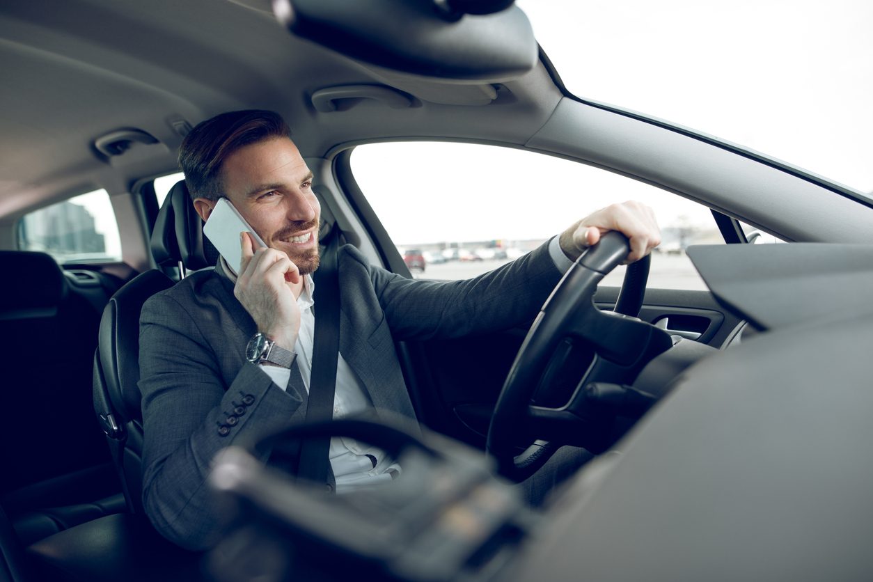 Driver holding a phone while driving