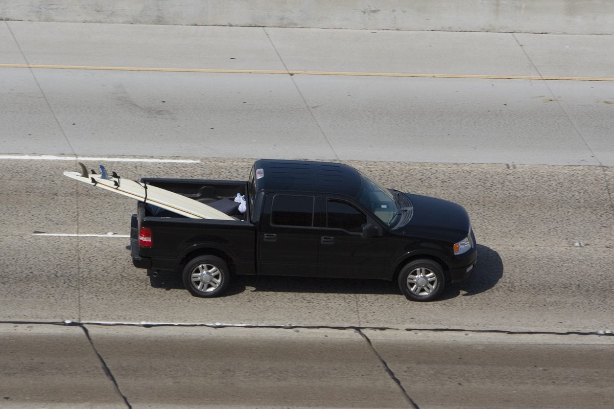 Full size pickup truck carrying surfboards seen from above