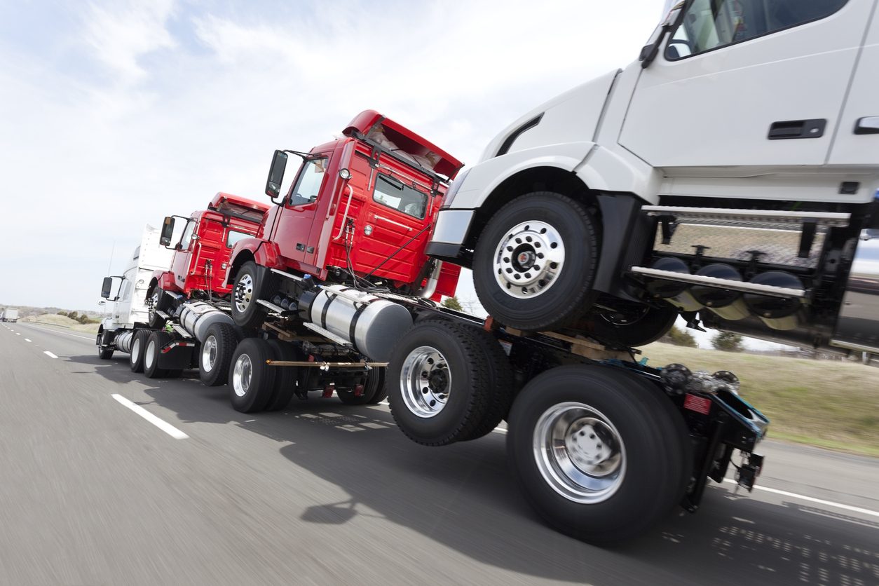 Truck tractors decked one on another for transport