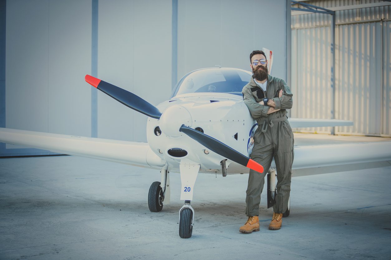Light aircraft with a red tipped propeller in a hangar
