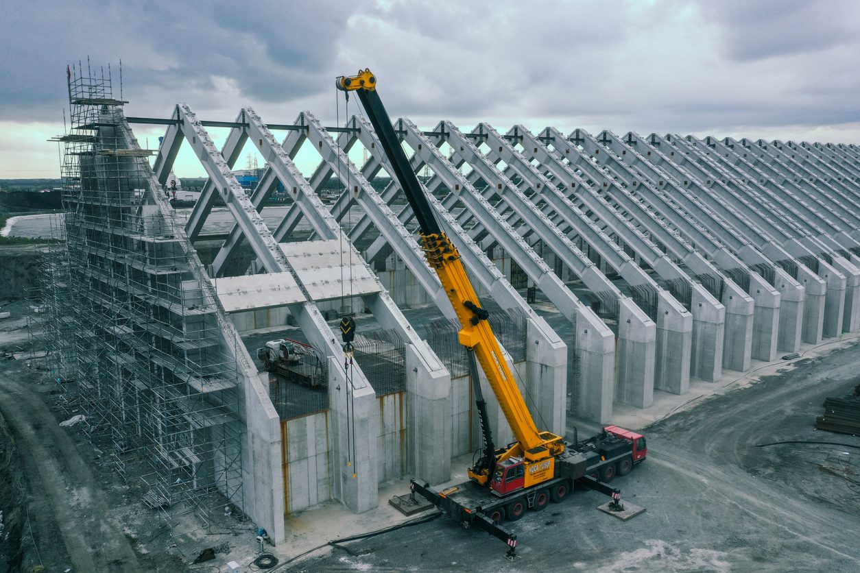 Precast concrete elements being placed by crane on site