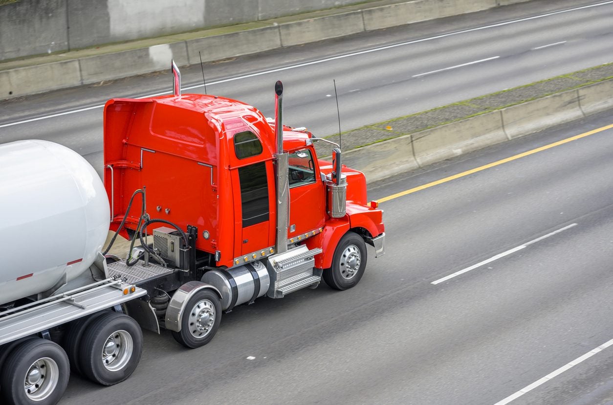 Conventional tractor unit traveling an interstate highway