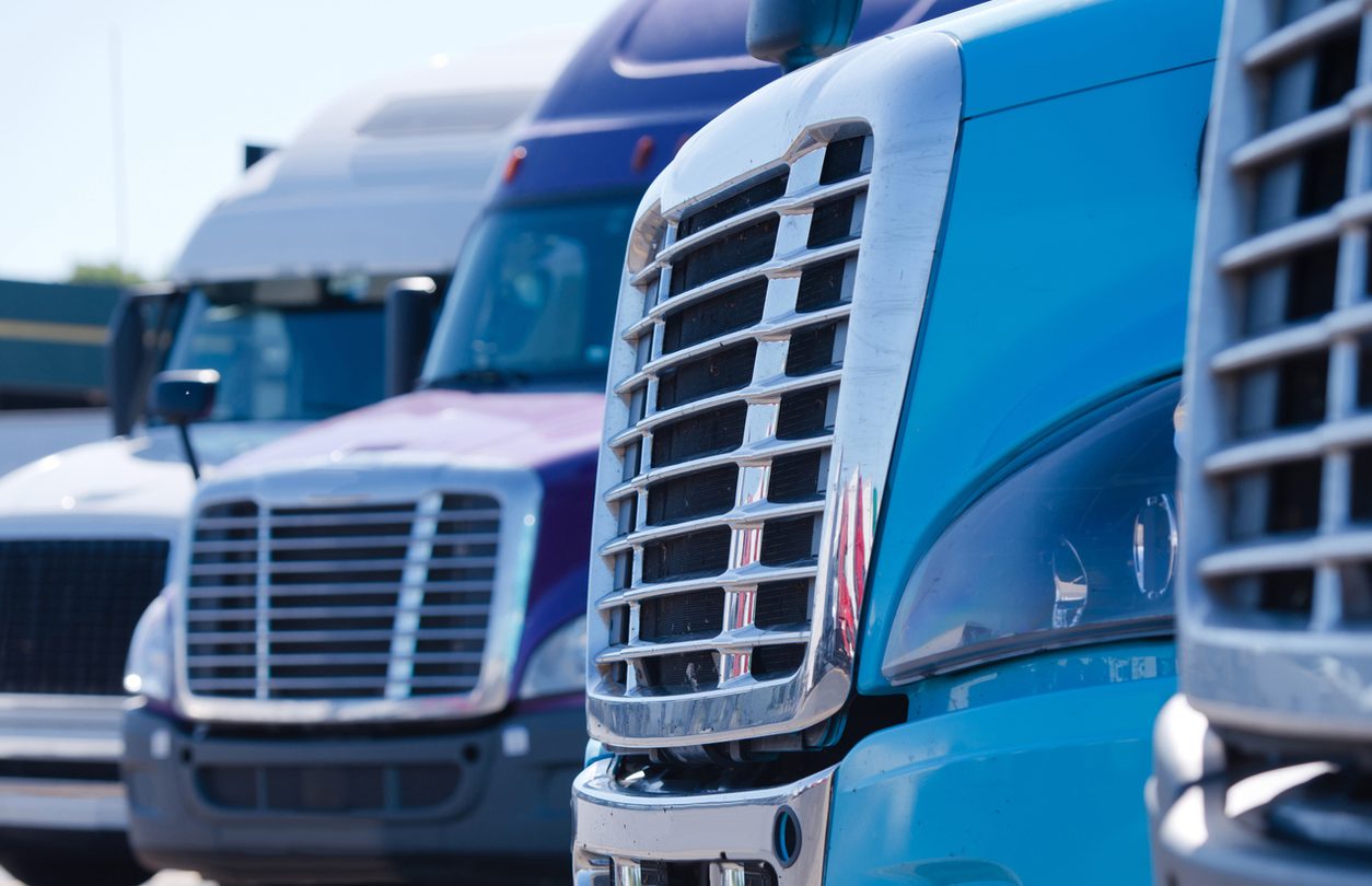 Grilles of conventional tractors parked in a row