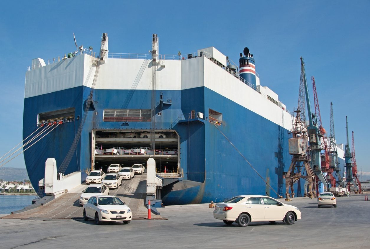 Cars driving up the stern ramp of a roll on roll off vessel