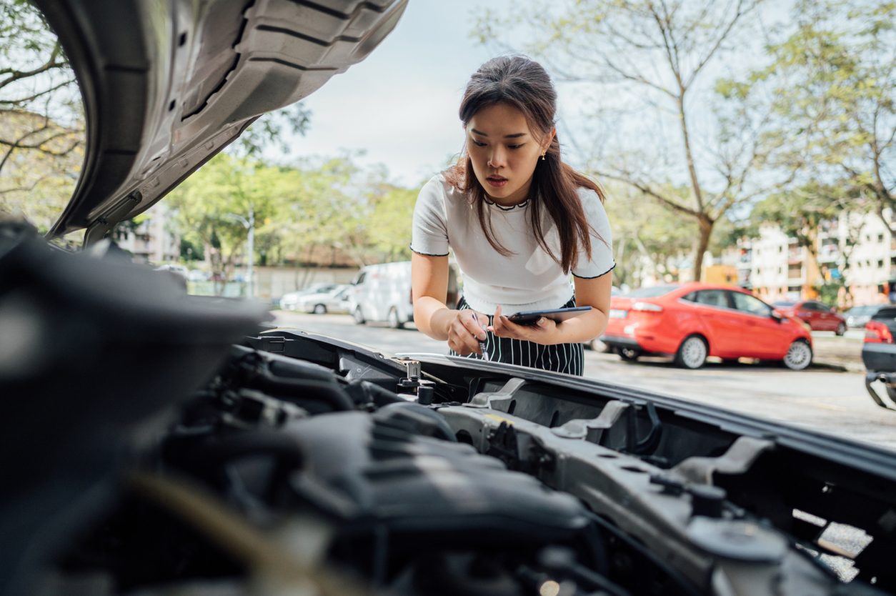 Inspecting damage under the hood of a vehicle before shipping