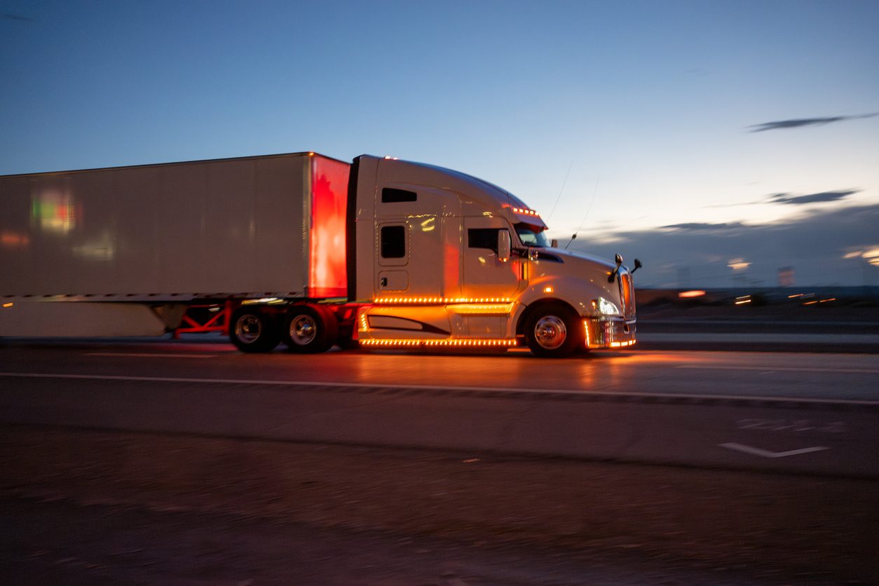 Semi truck running at dusk with marker lights on