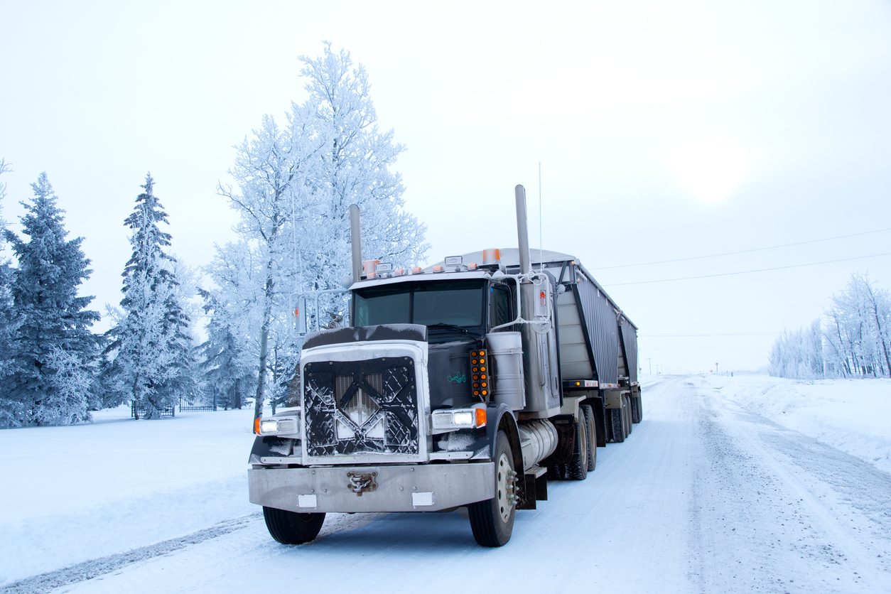 Conventional semi truck on a snow covered road in winter