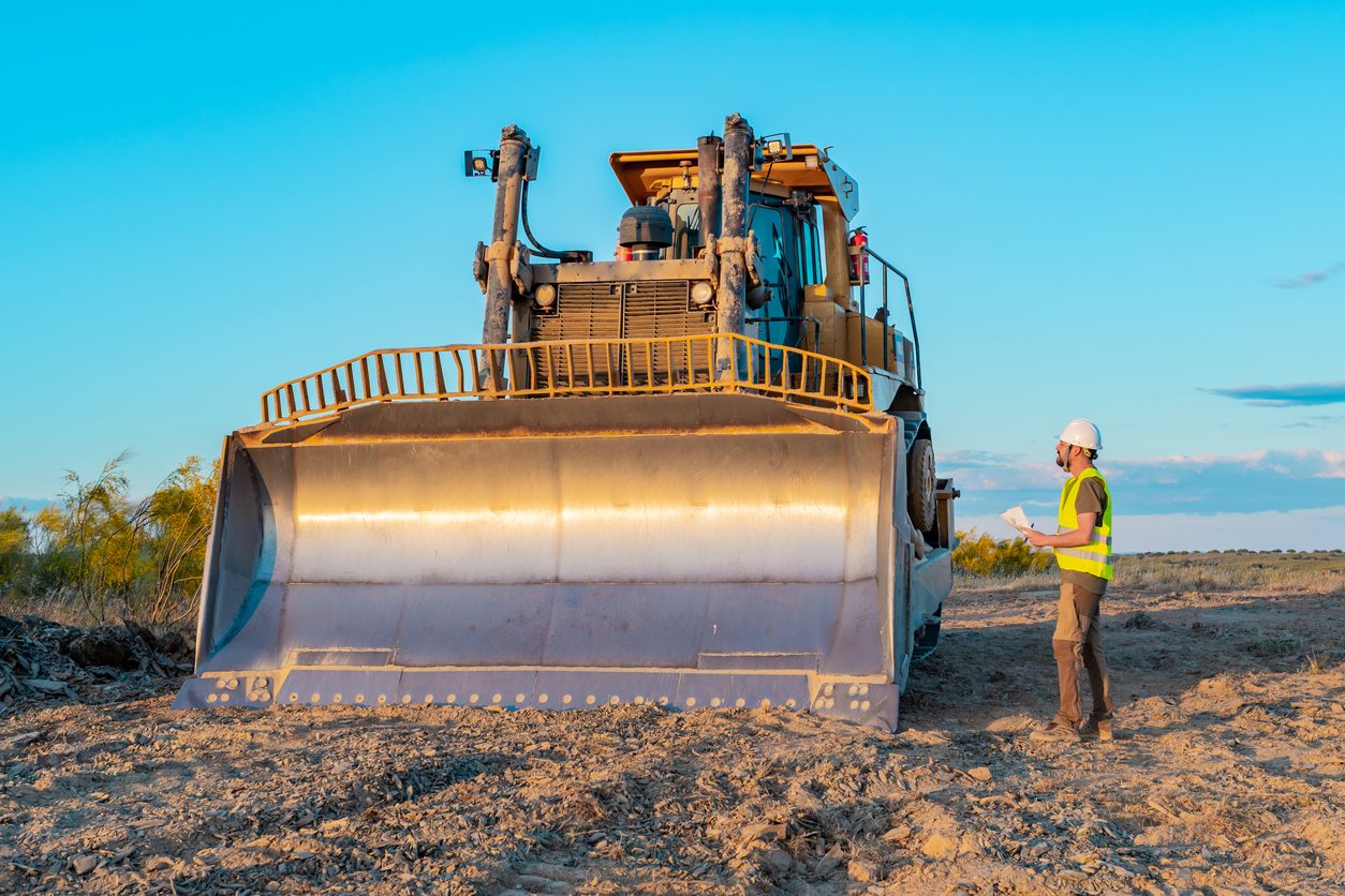 Site manager checking a dozer on an excavation site