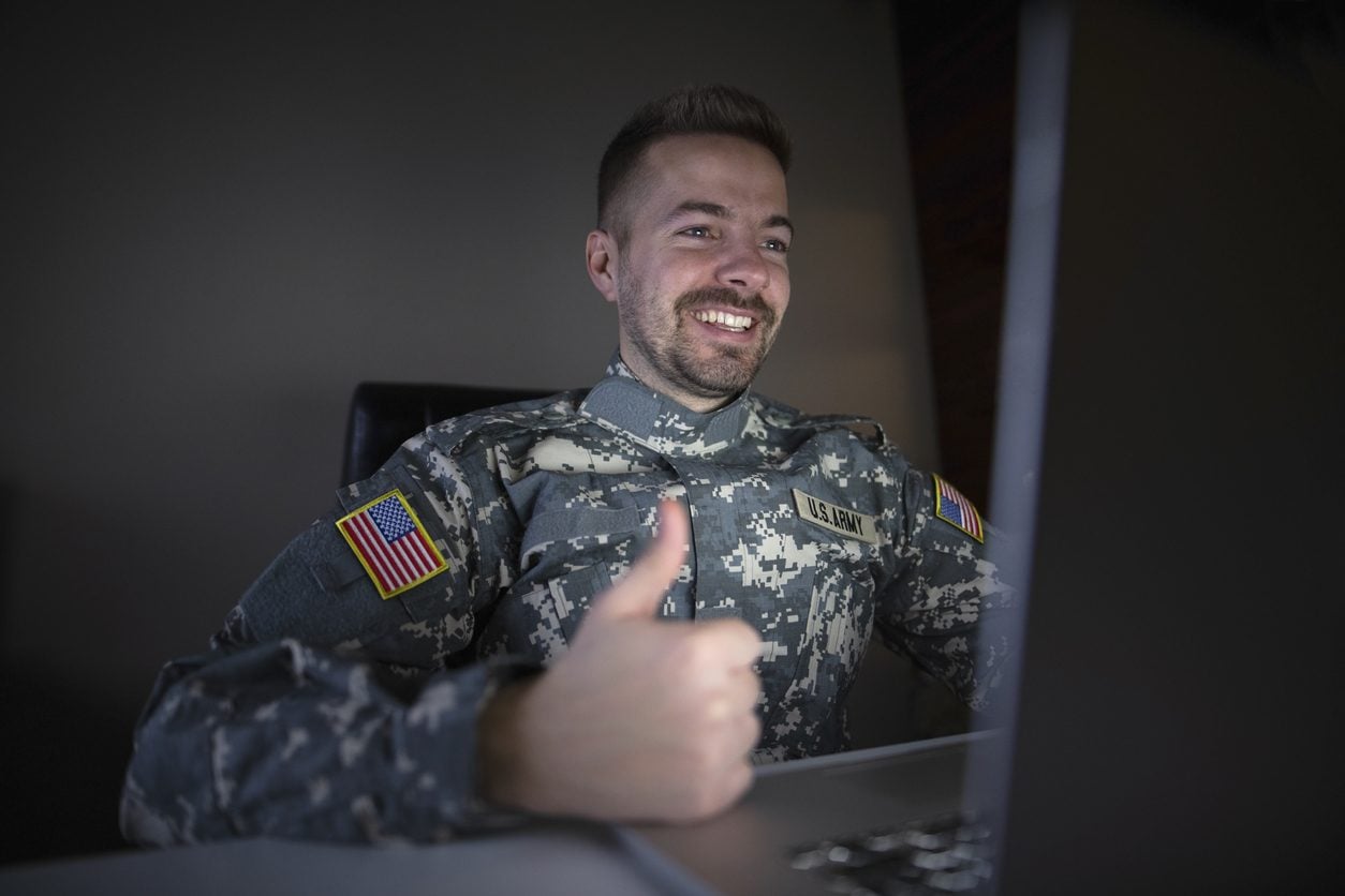 Service member booking transport on a laptop