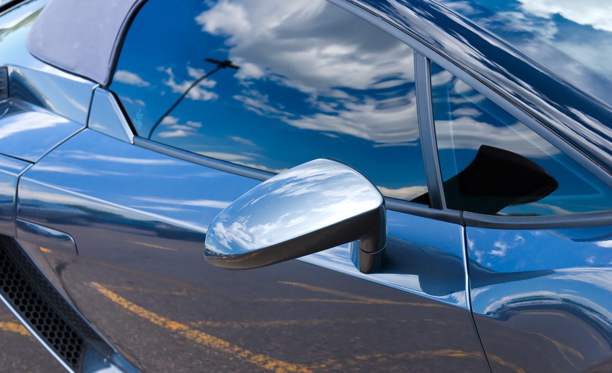 Reflections along the flank of a sports car