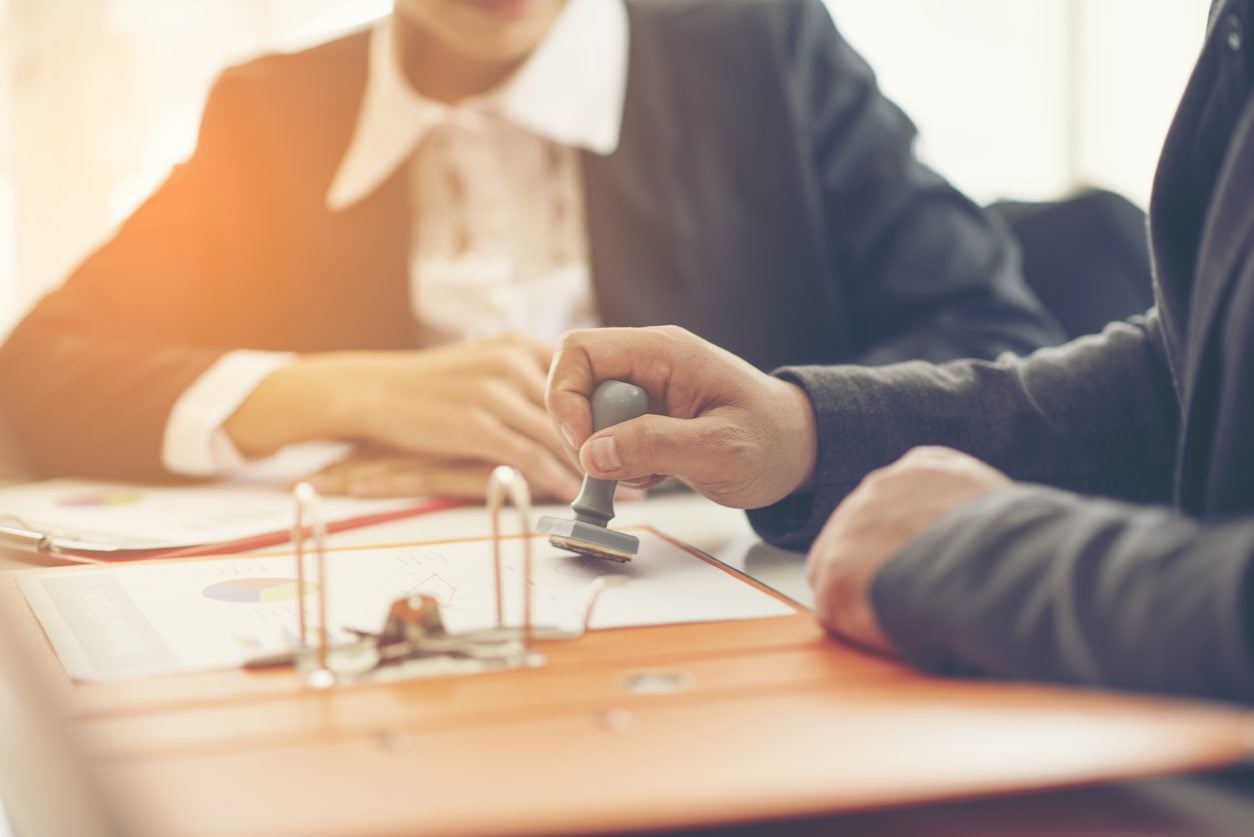Stamping a shipping document at a desk