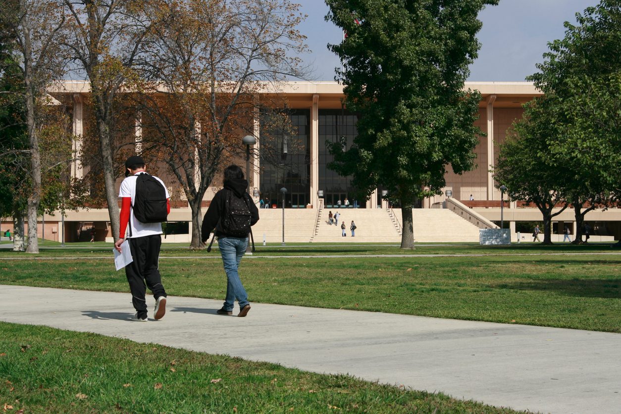 Students walking across a university campus