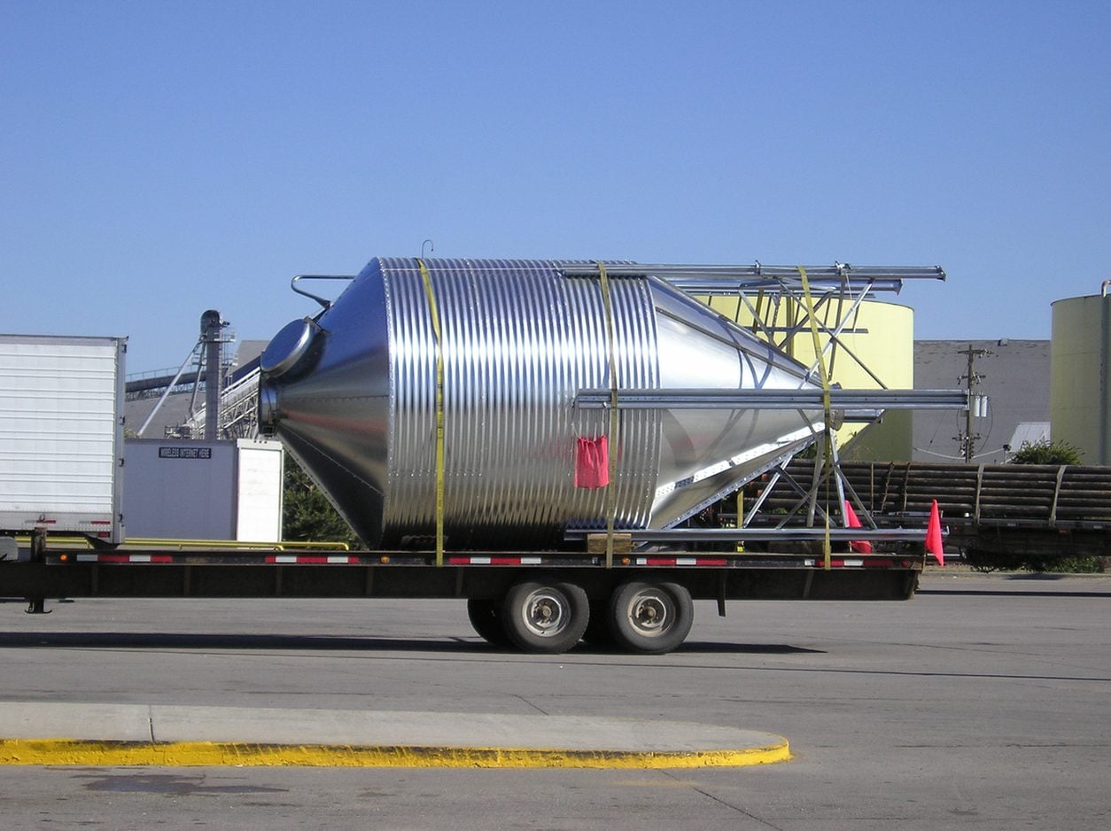 Cylindrical tank secured on a flatbed trailer
