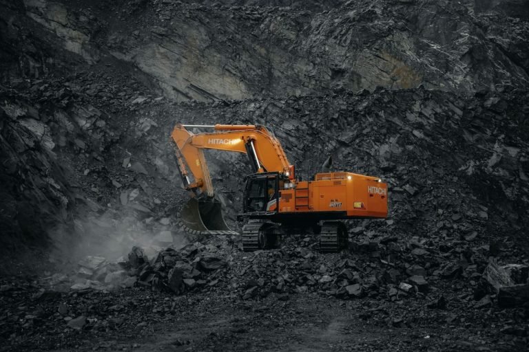 Excavator breaking rock in a quarry