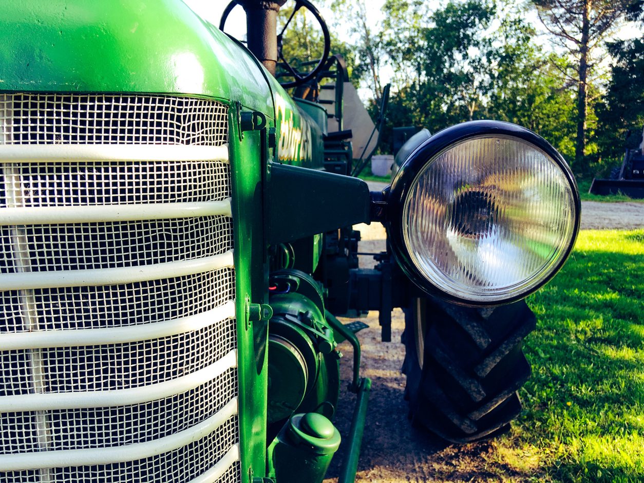 Close up of a vintage tractor grille and headlight