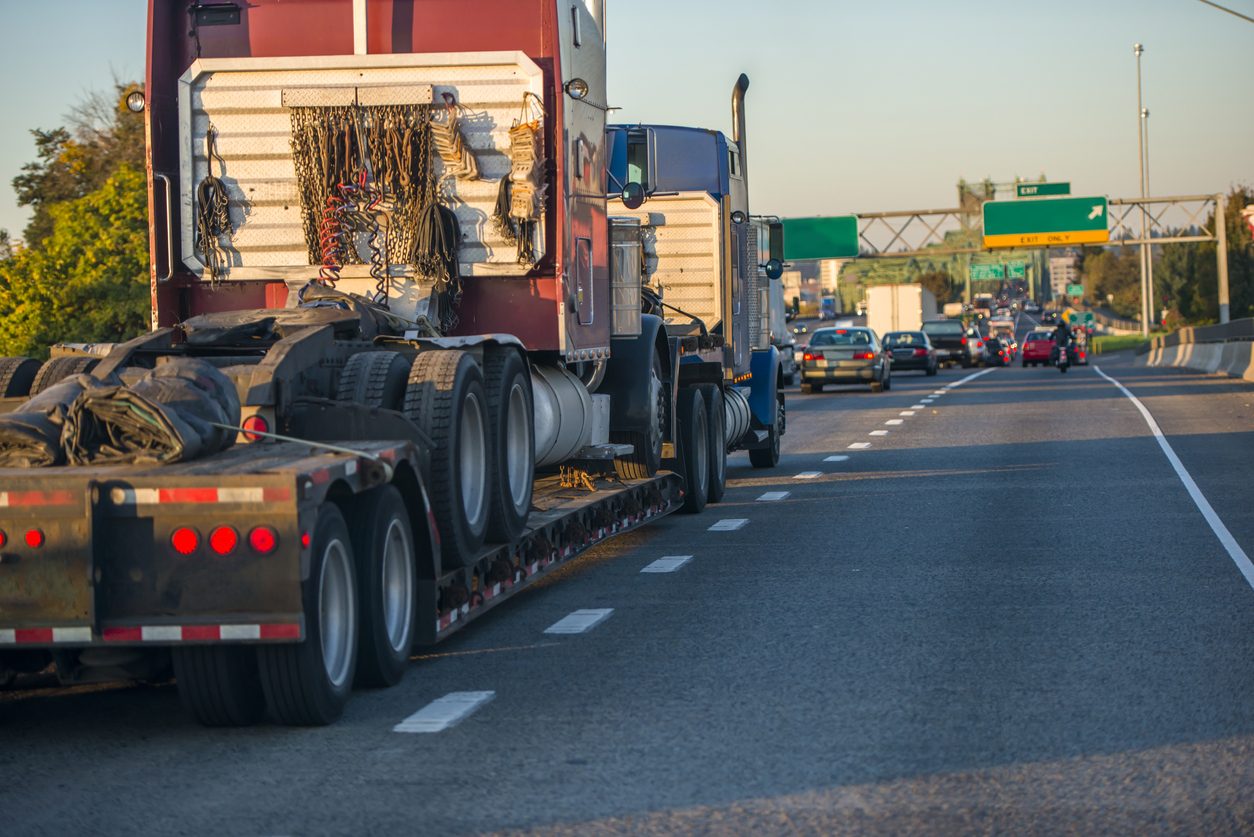 Truck tractor loaded on a step deck trailer