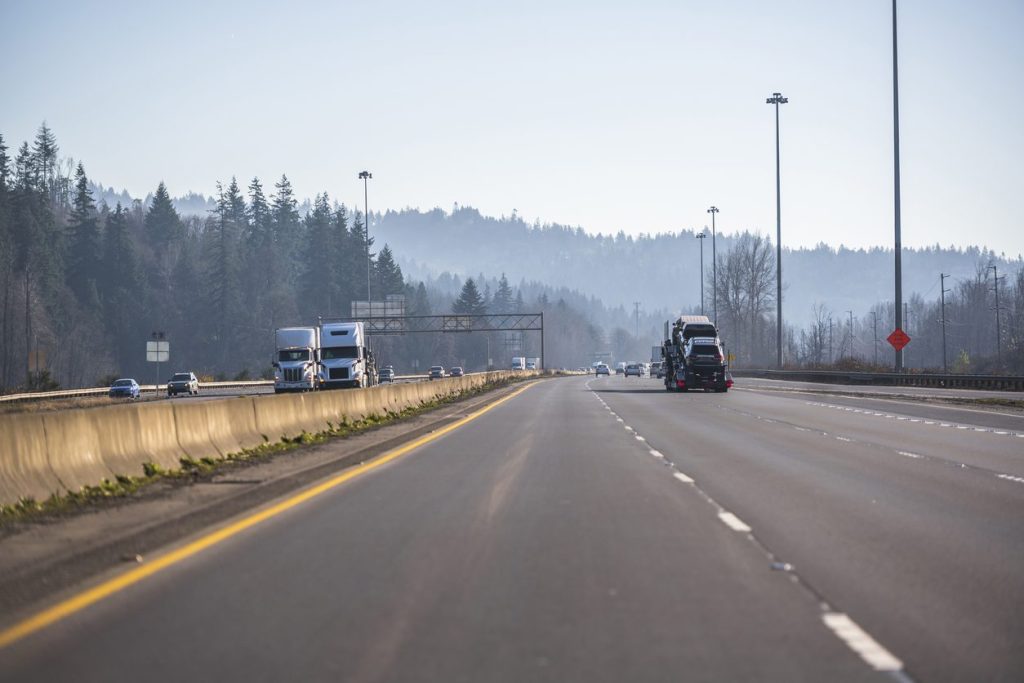Semi trucks running both directions on a divided highway