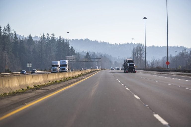 Semi trucks running both directions on a divided highway