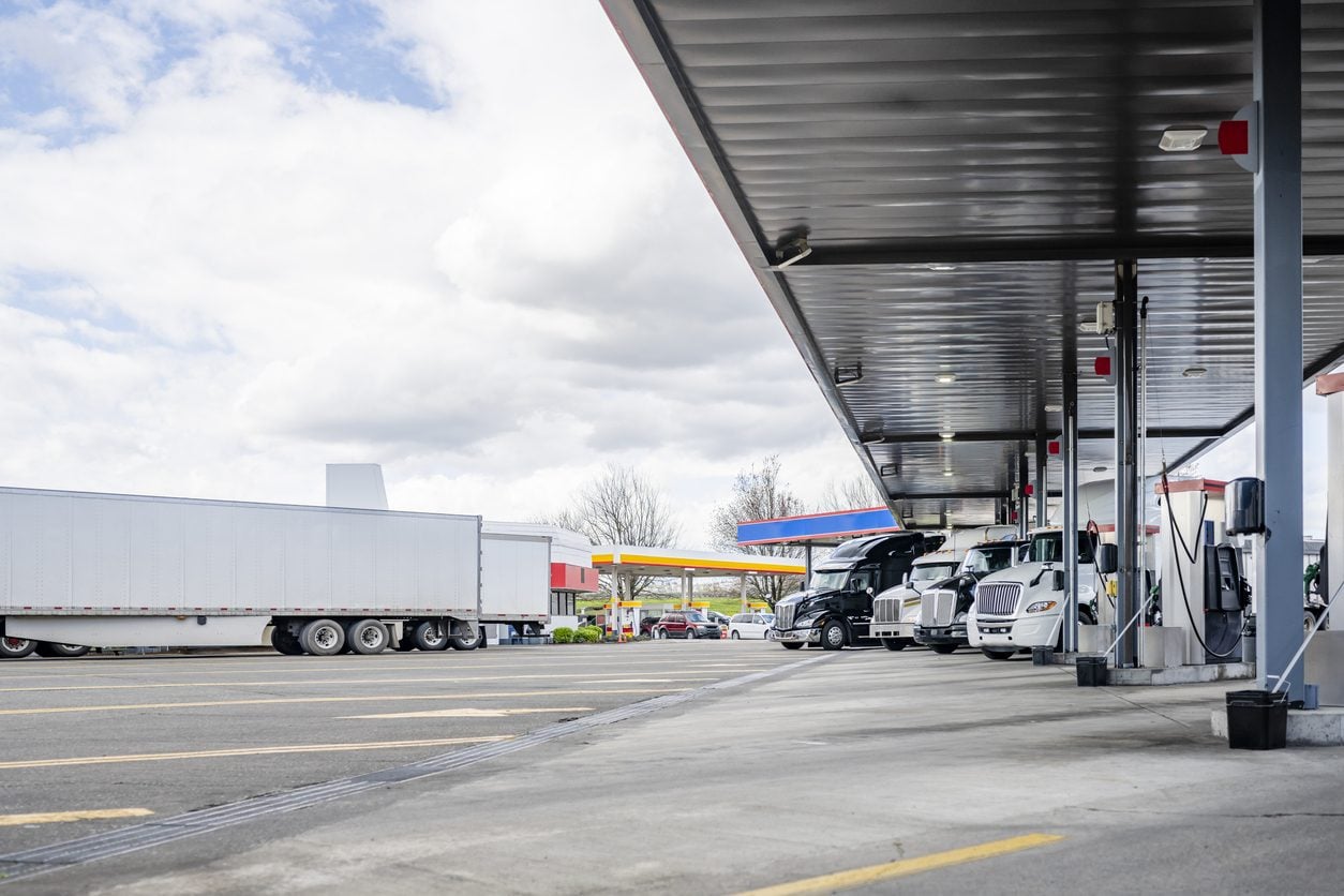 Semi trucks refueling at a truck stop fuel station