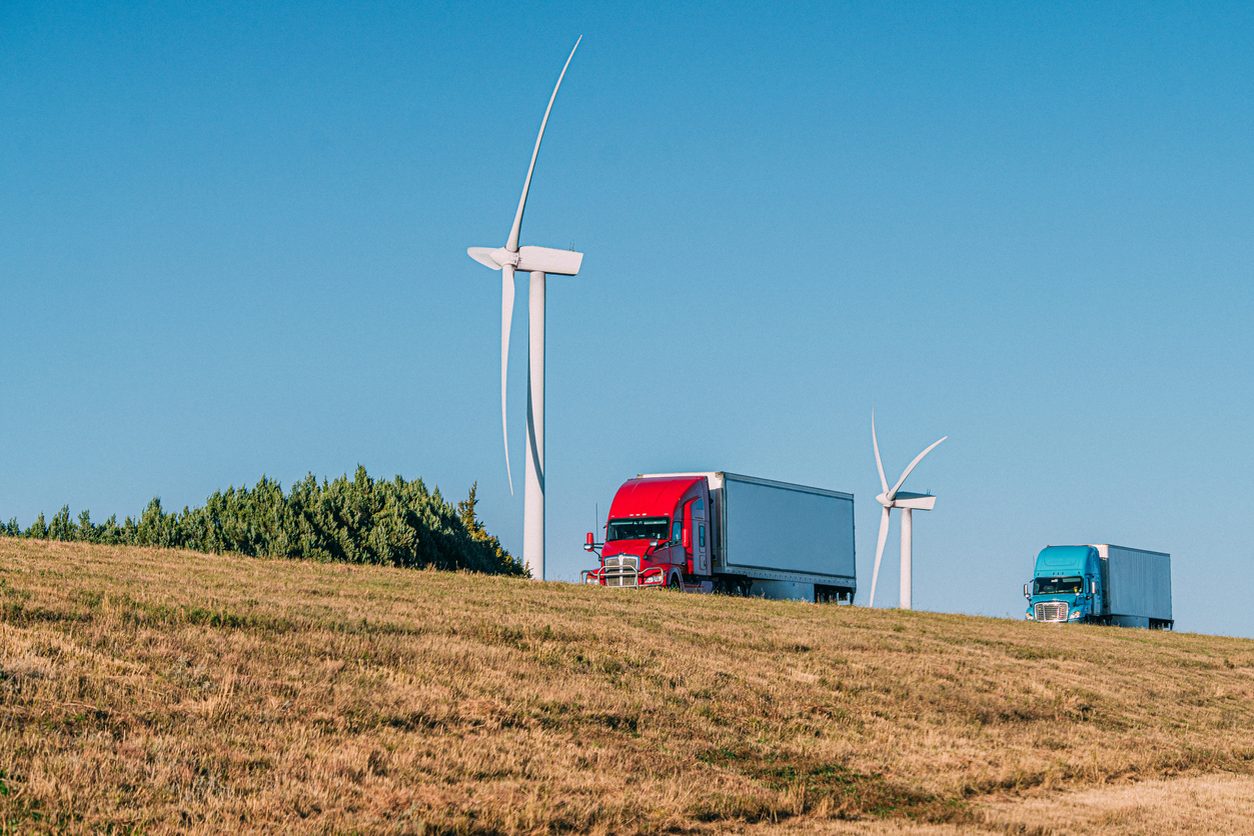 Semi trucks passing wind turbines