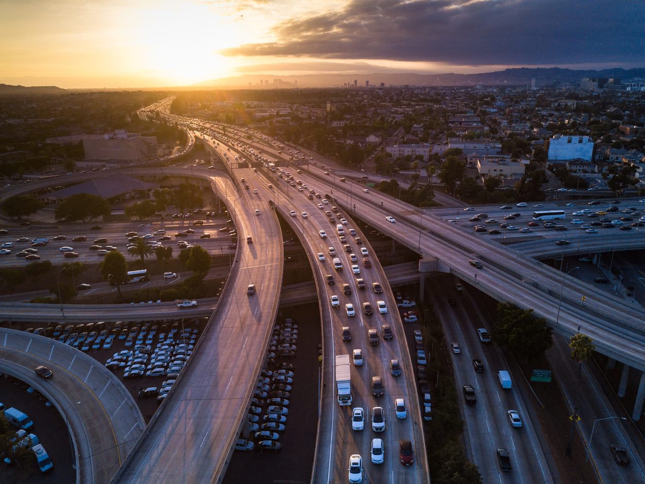 Aerial view of a multi level urban freeway interchange at sunset