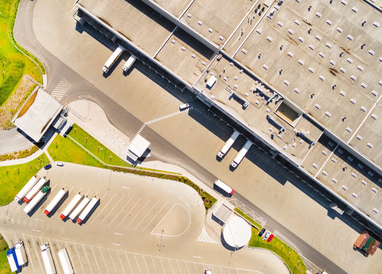 Aerial view of a warehouse with trucks at the docks