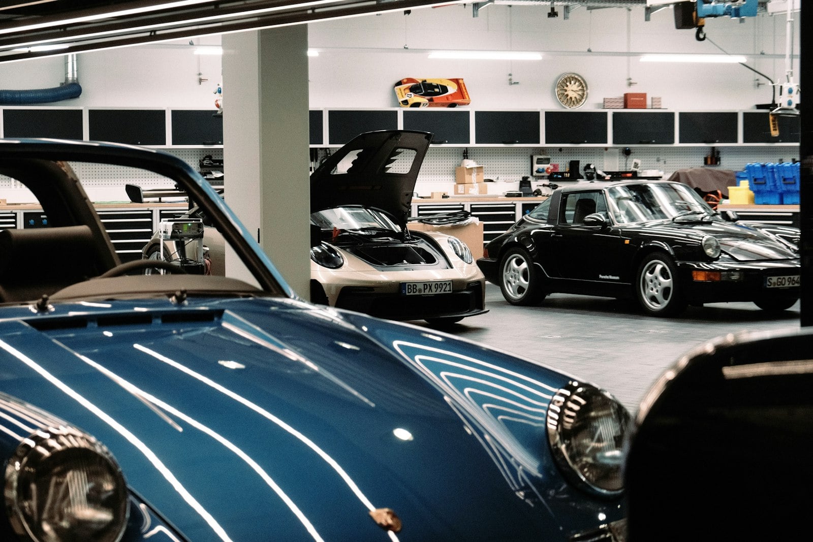 Porsche sports cars parked in a spotless private workshop